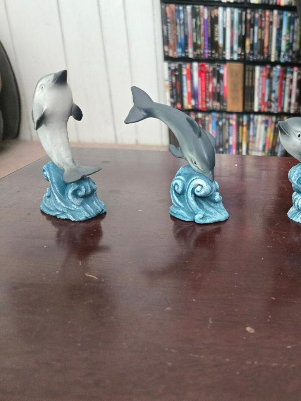 4 dolphins riding the waves